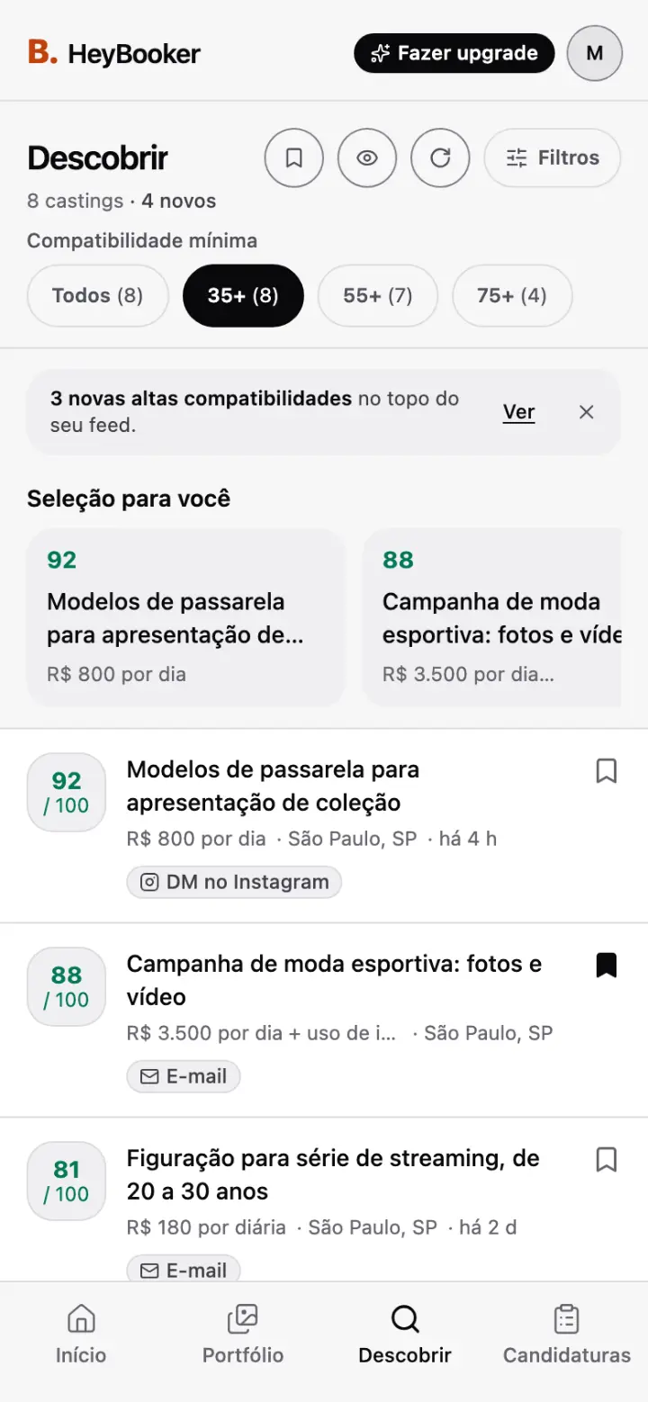 O feed Descobrir do app HeyBooker: oito castings ordenados por compatibilidade, com um de passarela em 92 de 100 e uma campanha de moda esportiva em 88, cada um com cachê, cidade e forma de candidatura.